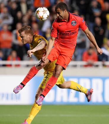 NICOSIA, Oct. 21, 2014 -- Paris Saint Germain s Lucas Moura (R) heads the ball during the Champions League Group F soccer match agains APOEL Nicosia at GSP Stadium in Nicosia, Cyprus, October 21, 2014. Paris Saint Germain won 1-0. ) (SP)CYPRUS-NICOSIA-UEFA-PSG VS NICOSIA SakisxSavvides 
