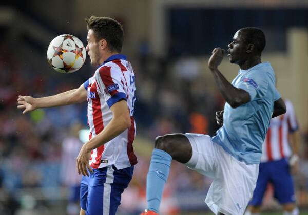 Atletico de Madrid Midfielder, Saul Aiguez Esclapez - SAUL, number 17 . Malmo FF Defender, Enock Kofi Adu - ENOCK KOFI ADU, number 8. Round 3 of the CHAMPIONS league, soccer match between Atletico de Madrid - Malmo FF at the Vicente Calderon stadium, Madrid - Spain by October 22, 2014. . 