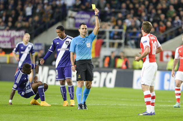 - BRUSSELS, BELGIUM: Arsenal s Nacho Monreal (R) receives a yellow card from the referee Carlos Velasco Carballo (C) during a third group stage game between RSCA Anderlecht and English team Arsenal, in the group D of the UEFA Champions League competition, Wednesday 22 October 2014. LAURIExDIEFFEMBACQ  premiumd 20145077