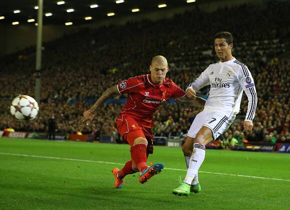 Cristiano Ronaldo of Real Madrid gets a cross in past Martin Skrtel of Liverpool - UEFA Champions League Group B - Liverpool vs Real Madrid - Anfield Stadium - Liverpool- England - 22nd October 2014 - Picture Simon Bellis Sportimage EDITORIAL USE ONLY. No use with unauthorised audio, video, data, fixture lists, club league logos or live services. Online in-match use limited to 120 images, no video emulation. No use in betting, games or single club league player publications.