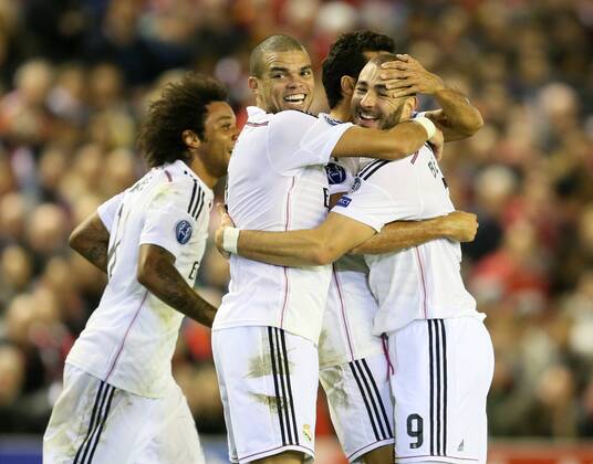 Karim Benzema of Real Madrid (r) is mobbed after scoring the second goal - UEFA Champions League Group B - Liverpool vs Real Madrid - Anfield Stadium - Liverpool- England - 22nd October 2014 - Picture Simon Bellis Sportimage EDITORIAL USE ONLY. No use with unauthorised audio, video, data, fixture lists, club league logos or live services. Online in-match use limited to 120 images, no video emulation. No use in betting, games or single club league player publications.