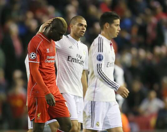 Pepe of Real Madrid consoles Mario Balotelli of Liverpool as they walk off at half time - UEFA Champions League Group B - Liverpool vs Real Madrid - Anfield Stadium - Liverpool- England - 22nd October 2014 - Picture Simon Bellis Sportimage EDITORIAL USE ONLY. No use with unauthorised audio, video, data, fixture lists, club league logos or live services. Online in-match use limited to 120 images, no video emulation. No use in betting, games or single club league player publications.