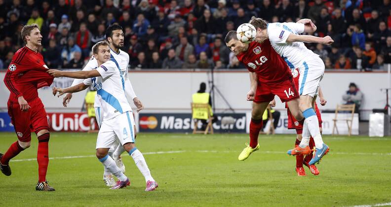 Leverkusens Kyriakos Papadopoulos (2.R) scoring the 2:0 against Ptersburgs Nicolas Lombaerts (R) during the Championsleague match between Bayer 04 Leverkusen and St. Petersburg, Bayarena in Leverkusen on October 22., 2014. Bayer 04 Leverkusen vs. St. Petersburg in der Gruppenphase der Champions League Qualifikation Saison 2014 2015 am 22. Oktober 2014.