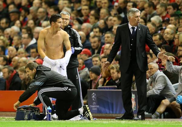 James Rodriguez of Real Madrid and Carlo Ancelotti manager of Real Madrid shout for a spare shirt - UEFA Champions League Group B - Liverpool vs Real Madrid - Anfield Stadium - Liverpool- England - 22nd October 2014 - Picture Simon Bellis Sportimage EDITORIAL USE ONLY. No use with unauthorised audio, video, data, fixture lists, club league logos or live services. Online in-match use limited to 120 images, no video emulation. No use in betting, games or single club league player publications.