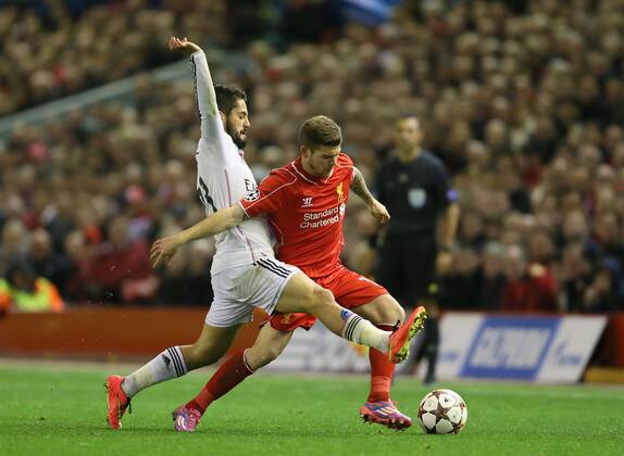 Alberto Moreno of Liverpool tackled by Isco of Real Madrid - UEFA Champions League Group B - Liverpool vs Real Madrid - Anfield Stadium - Liverpool- England - 22nd October 2014 - Picture Simon Bellis Sportimage EDITORIAL USE ONLY. No use with unauthorised audio, video, data, fixture lists, club league logos or live services. Online in-match use limited to 120 images, no video emulation. No use in betting, games or single club league player publications.