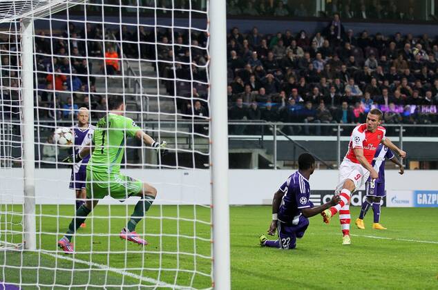 Arsenal s Lukas Podolski scoring his sides second goal - UEFA Champions League - RSC Anderlecht vs Arsenal - Constant Vanden Stock Stadium - Belgium - 22nd October 2014 - Picture David Klein Sportimage EDITORIAL USE ONLY. No use with unauthorised audio, video, data, fixture lists, club league logos or live services. Online in-match use limited to 120 images, no video emulation. No use in betting, games or single club league player publications.