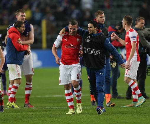 Arsenal s Lukas Podolski celebrates scoring his sides second goal at the final whistle - UEFA Champions League - RSC Anderlecht vs Arsenal - Constant Vanden Stock Stadium - Belgium - 22nd October 2014 - Picture David Klein Sportimage EDITORIAL USE ONLY. No use with unauthorised audio, video, data, fixture lists, club league logos or live services. Online in-match use limited to 120 images, no video emulation. No use in betting, games or single club league player publications.