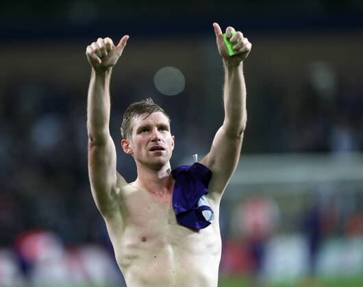 Arsenal s Per Mertesacker celebrates at the final whistle - UEFA Champions League - RSC Anderlecht vs Arsenal - Constant Vanden Stock Stadium - Belgium - 22nd October 2014 - Picture David Klein Sportimage EDITORIAL USE ONLY. No use with unauthorised audio, video, data, fixture lists, club league logos or live services. Online in-match use limited to 120 images, no video emulation. No use in betting, games or single club league player publications.