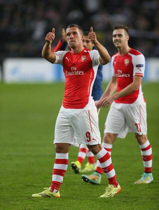 Arsenal s Lukas Podolski celebrates scoring his sides second goal at the final whistle - UEFA Champions League - RSC Anderlecht vs Arsenal - Constant Vanden Stock Stadium - Belgium - 22nd October 2014 - Picture David Klein Sportimage EDITORIAL USE ONLY. No use with unauthorised audio, video, data, fixture lists, club league logos or live services. Online in-match use limited to 120 images, no video emulation. No use in betting, games or single club league player publications.