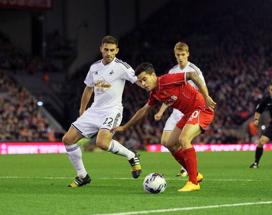 Liverpool s Philippe Coutinho tussles with Swansea s Angel Rangel League Cup Fourth Round- Liverpool vs Swansea City - Anfield - England - 28th October 2014 - Picture David Klein Sportimage EDITORIAL USE ONLY. No use with unauthorised audio, video, data, fixture lists, club league logos or live services. Online in-match use limited to 120 images, no video emulation. No use in betting, games or single club league player publications.