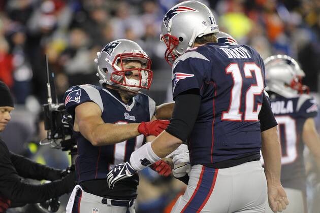 New England Patriots quarterback Tom Brady (12) celebrates with wide receiver Julian Edelman (11) after Brady connected with Edelman for a five-yard touchdown reception in the second quarter against the Denver Broncos at Gillette Stadium in Foxboro, Massachusetts on November 2, 2014.  BOS2014110206
