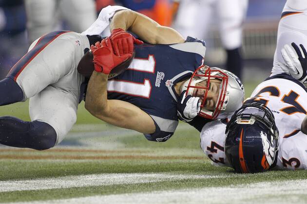New England Patriots wide receiver Julian Edelman (11) rolls in the end zone with Denver Broncos safety T.J. Ward (43) on a five-yard touchdown reception in the second quarter at Gillette Stadium in Foxboro, Massachusetts on November 2, 2014. The Patriots defeated the Broncos 43-21.  BOS2014110207