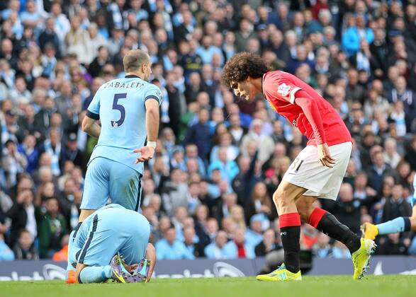 Spit comes out of the mouth of Manchester United s Marouane Fellaini as he shouts at Manchester City s Sergio Kun Agüero - Barclays Premier League - Manchester City vs Manchester Utd - Etihad Stadium - Manchester - England - 2nd November 2014 - EDITORIAL USE ONLY. No use with unauthorised audio, video, data, fixture lists, club league logos or live services. Online in-match use limited to 120 images, no video emulation. No use in betting, games or single club league player publications.