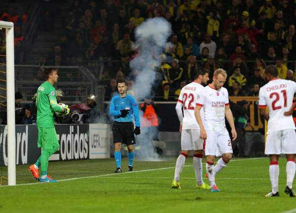 UEFA Champions League Group D match between Borussia Dortmund and Galatasaray at Signal Iduna Park on November 04, 2014 in Dortmund, Germany Score: Borussia Dortmund 4 - Galatasaray 1 Pictured: Fireworks are thrown onto the pitch by Galatasaray fans during the UEFA Champions League Group D match between Borussia Dortmund and Galatasaray AS at Signal Iduna Park on November 4, 2014 in Dortmund, Germany. 