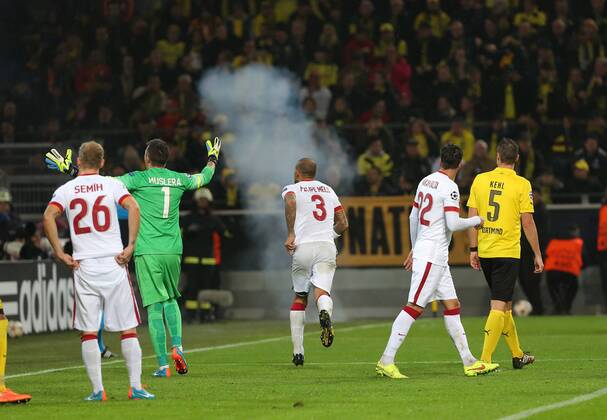 UEFA Champions League Group D match between Borussia Dortmund and Galatasaray at Signal Iduna Park on November 04, 2014 in Dortmund, Germany Score: Borussia Dortmund 4 - Galatasaray 1 Pictured: Fireworks are thrown onto the pitch by Galatasaray fans during the UEFA Champions League Group D match between Borussia Dortmund and Galatasaray AS at Signal Iduna Park on November 4, 2014 in Dortmund, Germany. 
