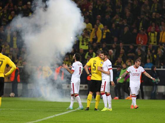 UEFA Champions League Group D match between Borussia Dortmund and Galatasaray at Signal Iduna Park on November 04, 2014 in Dortmund, Germany Score: Borussia Dortmund 4 - Galatasaray 1 Pictured: Fireworks are thrown onto the pitch by Galatasaray fans during the UEFA Champions League Group D match between Borussia Dortmund and Galatasaray AS at Signal Iduna Park on November 4, 2014 in Dortmund, Germany. 