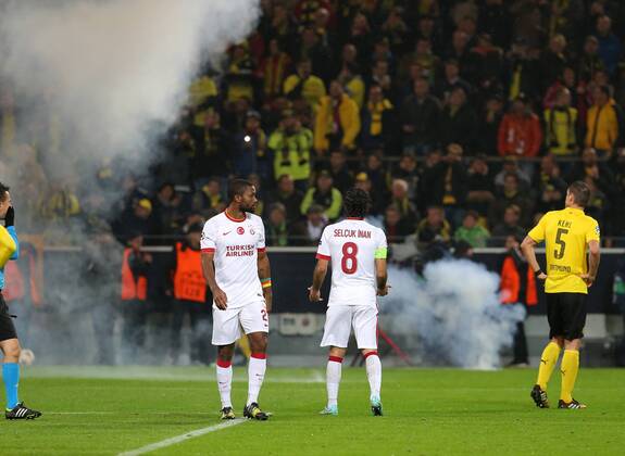UEFA Champions League Group D match between Borussia Dortmund and Galatasaray at Signal Iduna Park on November 04, 2014 in Dortmund, Germany Score: Borussia Dortmund 4 - Galatasaray 1 Pictured: Fireworks are thrown onto the pitch by Galatasaray fans during the UEFA Champions League Group D match between Borussia Dortmund and Galatasaray AS at Signal Iduna Park on November 4, 2014 in Dortmund, Germany. 
