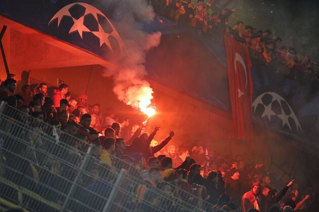 Borussia Dortmund vs. Galatasaray Istanbul --- Fussball --- Champions League --- 04.11.2014 Galatasaray, Fans mit Pyrotechnik, Pyros, Bengalisches Feuer, Bengalos, Krawalle, Unruhe, Randale, rechts die Fahne, Flagge der Tuerkei, im Hintergrund das Logo der Champions League, Symbolfoto, Symbolbild, Feature, Hinterleger, Hintergrund, Sicherheit, Anhänger, Anhaenger, Zuschauer, Ultras
