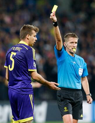 SOCCER - CL, Maribor vs Chelsea MARIBOR,SLOVENIA,05.NOV.14 - SOCCER - UEFA Champions League, group stage, NK Maribor vs Chelsea FC. Image shows Zeljko Filipovic (Maribor) and referee Daniele Orsato (ITA). Keywords: yellow card. 
