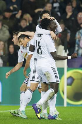 Football - 2014 2015 Premier League - Swansea City vs. Arsenal Bafétimbi Gomis of Swansea celebrates scoring their 2nd goal at The Liberty Stadium. COLORSPORT WINSTON BYNORTH 