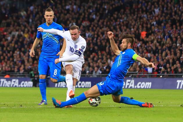 Wayne Rooney of England gets a shot blocked - England vs. Slovenia - UEFA Euro 2016 Qualifying - Wembley Stadium - London - 15 11 2014 Pic Philip Oldham Sportimage EDITORIAL USE ONLY. No use with unauthorised audio, video, data, fixture lists, club league logos or live services. Online in-match use limited to 120 images, no video emulation. No use in betting, games or single club league player publications.