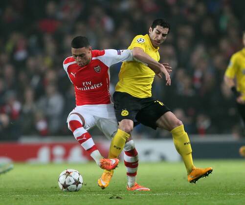 Arsenal s Alex Oxlade-Chamberlain tussles with Dortmund s Henrikh Mkhitaryan UEFA Champions League- Arsenal vs Borussia Dortmund- Emirates Stadium - England - 26th November 2014 - EDITORIAL USE ONLY. No use with unauthorised audio, video, data, fixture lists, club league logos or live services. Online in-match use limited to 120 images, no video emulation. No use in betting, games or single club league player publications.