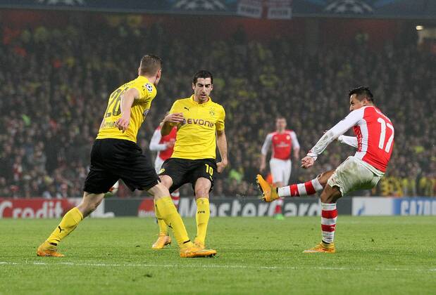 Arsenal s Alexis Sanchez scoring his sides second goal UEFA Champions League- Arsenal vs Borussia Dortmund- Emirates Stadium - England - 26th November 2014 - EDITORIAL USE ONLY. No use with unauthorised audio, video, data, fixture lists, club league logos or live services. Online in-match use limited to 120 images, no video emulation. No use in betting, games or single club league player publications.