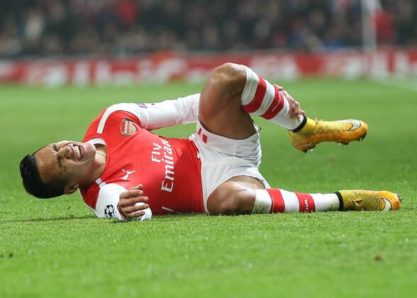 Football - 2014 2015 Champions League - Group D: Arsenal vs. Borussia Dortmund, Arsenal s Alexis Sanchez goes down clutching his shin at The Emirates Stadium  ARS_DOR