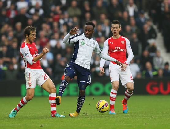 West Brom s Saido Berahino tussles with Arsenal s Mathieu Flamini - Barclays Premier League - West Bromwich Albion vs FC Arsenal London - The Hawthorns - England - 29th November 2014 - EDITORIAL USE ONLY. No use with unauthorised audio, video, data, fixture lists, club league logos or live services. Online in-match use limited to 120 images, no video emulation. No use in betting, games or single club league player publications.