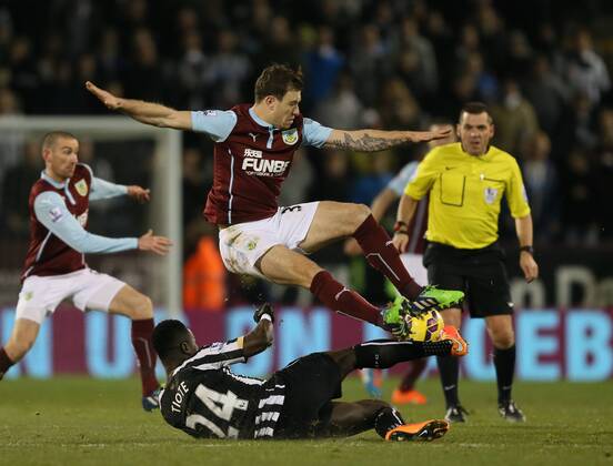 Ashley Barnes of Burnley tackled by Cheik Ismael Tiote of Newcastle United - Barclays Premier League - Burnley vs Newcastle Utd - Turf Moor Stadium - England - 2nd December 2014 - EDITORIAL USE ONLY. No use with unauthorised audio, video, data, fixture lists, club league logos or live services. Online in-match use limited to 120 images, no video emulation. No use in betting, games or single club league player publications.