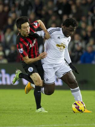 Football - 2014 2015 Premier League - Swansea City vs. Queens Park Rangers Wilfried Bony of Swansea attacks at The Liberty Stadium. COLORSPORT WINSTON BYNORTH 