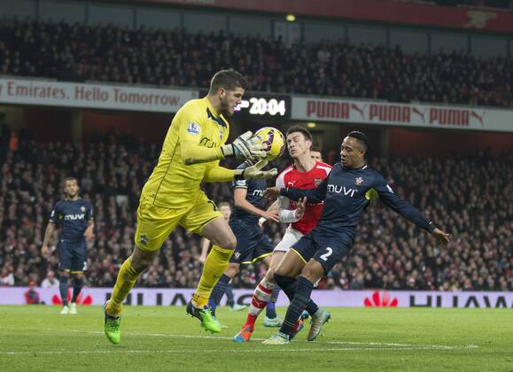 03.12.2014. London, England. Premier League. Arsenal versus Southampton. Southampton s Fraser Forster collects the ball under pressure from Arsenal s Laurent Koscielny. xNigelxCookex  ActionPlus11580816