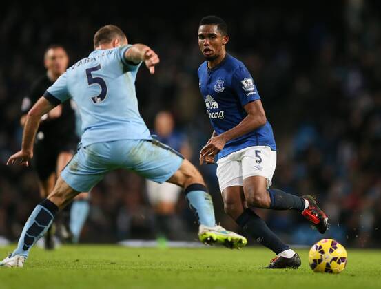 Samuel Eto o of Everton flicks the ball past Pablo Zabaleta of Manchester City - Barclays Premier League - Manchester City vs FC Everton - Etihad Stadium - Manchester - England - 6th December 2014 - EDITORIAL USE ONLY. No use with unauthorised audio, video, data, fixture lists, club league logos or live services. Online in-match use limited to 120 images, no video emulation. No use in betting, games or single club league player publications.