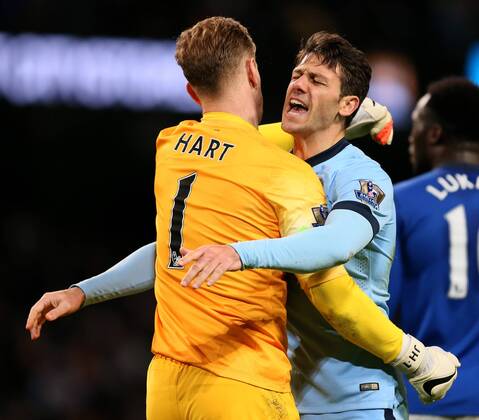 Joe Hart of Manchester City and Martin Demichelis of Manchester City celebrate the win - Barclays Premier League - Manchester City vs FC Everton - Etihad Stadium - Manchester - England - 6th December 2014 - EDITORIAL USE ONLY. No use with unauthorised audio, video, data, fixture lists, club league logos or live services. Online in-match use limited to 120 images, no video emulation. No use in betting, games or single club league player publications.