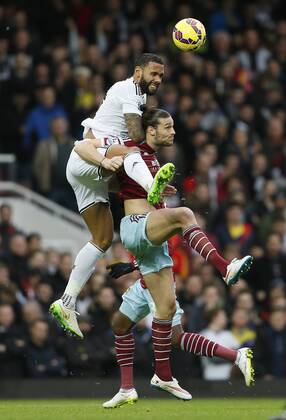 West Ham s Andy Carroll tussles with Swansea s Kyle Bartley Barclays Premier League- West Ham United vs Swansea City - Upton Park - England - 7th December 2014 - Picture David Klein Sportimage EDITORIAL USE ONLY. No use with unauthorised audio, video, data, fixture lists, club league logos or live services. Online in-match use limited to 120 images, no video emulation. No use in betting, games or single club league player publications.