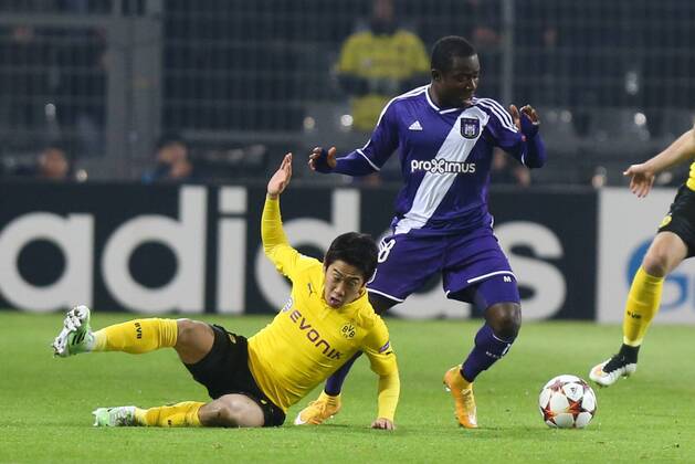 - DORTMUND, GERMANY: Dortmund s Shinji Kagawa and Anderlecht s Frank Acheampong fight for the ball during a soccer game between German team Borussia Dortmund and Belgium s RSC Anderlecht, Tuesday 09 December 2014 in Dortmund, Germany, on the sixth and last day of the group stage of the UEFA Champions League competition, in the group D VIRGINIExLEFOUR  x04518377x