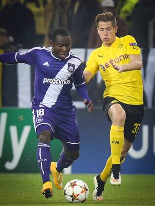 - DORTMUND, GERMANY: Anderlecht s Frank Acheampong and Dortmund s Erik Durm fight for the ball during a soccer game between German team Borussia Dortmund and Belgium s RSC Anderlecht, Tuesday 09 December 2014 in Dortmund, Germany, on the sixth and last day of the group stage of the UEFA Champions League competition, in the group D VIRGINIExLEFOUR  x04518380x