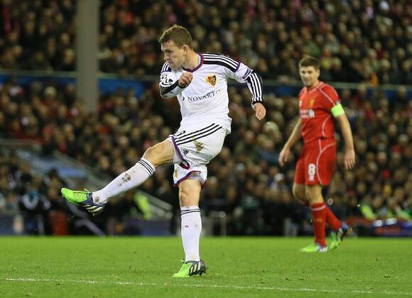 Fabian Frei of Basel scores as Steven Gerrard of Liverpool looks on - UEFA Champions League group B - Liverpool vs Basel - Anfield Stadium - Liverpool - England - 9th December 2014 - Picture Simon Bellis Sportimage EDITORIAL USE ONLY. No use with unauthorised audio, video, data, fixture lists, club league logos or live services. Online in-match use limited to 120 images, no video emulation. No use in betting, games or single club league player publications.