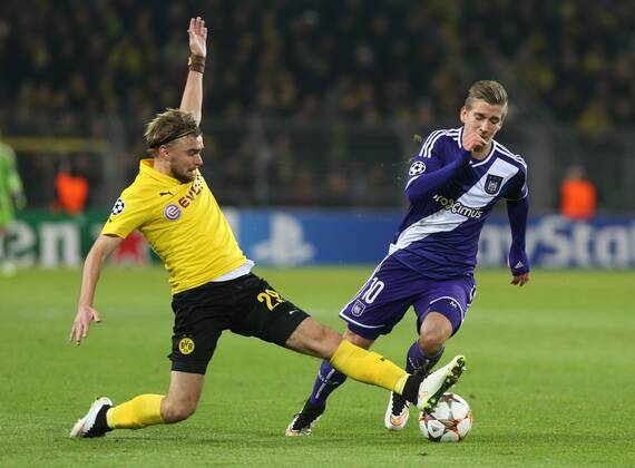 - DORTMUND, GERMANY: Dortmund s Marcel Schmelzer and Anderlecht s Dennis Praet fight for the ball during a soccer game between German team Borussia Dortmund and Belgium s RSC Anderlecht, Tuesday 09 December 2014 in Dortmund, Germany, on the sixth and last day of the group stage of the UEFA Champions League competition, in the group D VIRGINIExLEFOUR  x04518421x