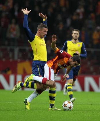 UEFA Champions League Group D match between Galatasaray and Arsenal at Turk Telekom Arena Stadium on December 09, 2014 in Istanbul, Turkey Pictured: Lukas Podolski of Arsenal and Tarik Camdal of Galatasaray. 