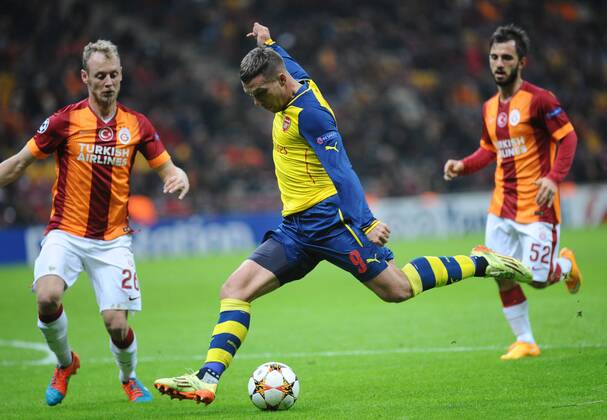 UEFA Champions League Group D match between Galatasaray and Arsenal at Turk Telekom Arena Stadium on December 09, 2014 in Istanbul, Turkey Pictured:Semih Kaya (L) of Galatasaray and Lukas Podolski of Arsenal. 