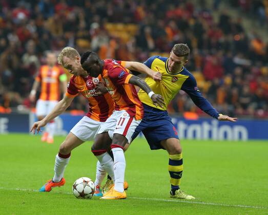 UEFA Champions League Group D match between Galatasaray and Arsenal at Turk Telekom Arena Stadium on December 09, 2014 in Istanbul, Turkey Pictured: Bruma and Semih Kaya of Galatasaray and Lukas Podolski of Arsenal. 