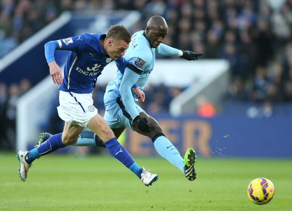 Jamie Vardy of Leicester City has a shot on goal as Eliaquim Mangala of Manchester City closes in - Barclays Premier League - Leicester City vs Manchester City - King Power Stadium - Leicester - England - 13th December 2014 - EDITORIAL USE ONLY. No use with unauthorised audio, video, data, fixture lists, club league logos or live services. Online in-match use limited to 120 images, no video emulation. No use in betting, games or single club league player publications.