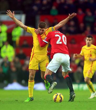 Robin van Persie of Manchester United ManU battles Steven Gerrard of Liverpool - Manchester United vs. Liverpool - Barclay s Premier League - Old Trafford - Manchester - 14 12 2014 Pic Philip Oldham Sportimage EDITORIAL USE ONLY. No use with unauthorised audio, video, data, fixture lists, club league logos or live services. Online in-match use limited to 120 images, no video emulation. No use in betting, games or single club league player publications.