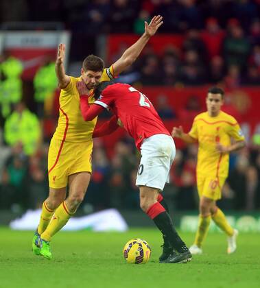 Robin van Persie of Manchester United ManU battles Steven Gerrard of Liverpool - Manchester United vs. Liverpool - Barclay s Premier League - Old Trafford - Manchester - 14 12 2014 Pic Philip Oldham Sportimage EDITORIAL USE ONLY. No use with unauthorised audio, video, data, fixture lists, club league logos or live services. Online in-match use limited to 120 images, no video emulation. No use in betting, games or single club league player publications.