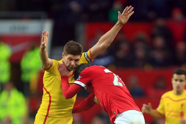 Robin van Persie of Manchester United ManU battles Steven Gerrard of Liverpool - Manchester United vs. Liverpool - Barclay s Premier League - Old Trafford - Manchester - 14 12 2014 Pic Philip Oldham Sportimage EDITORIAL USE ONLY. No use with unauthorised audio, video, data, fixture lists, club league logos or live services. Online in-match use limited to 120 images, no video emulation. No use in betting, games or single club league player publications.