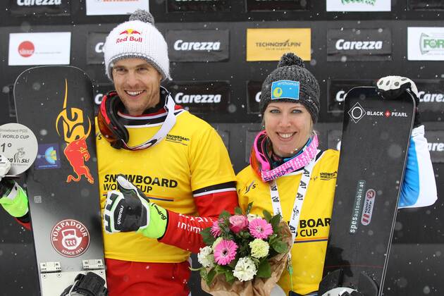 SNOWBOARD - FIS WC Carezza CAREZZA,ITALY,16.DEC.14 - SNOWBOARD - FIS World Cup, parallel giant slalom, award ceremony. Image shows Roland Fischnaller (ITA) and Marion Kreiner (AUT). Keywords: trophy.