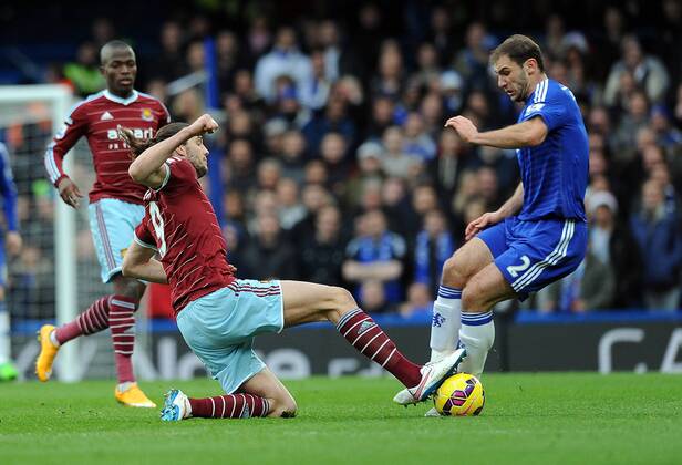 Andy Carroll of West Ham United tackles Branislav Ivanovic of Chelsea - Barclays Premier League - Chelsea vs West Ham United - Stamford Bridge Stadium - London - England - 26th December 2014 - Pic Robin Parker Sportimage EDITORIAL USE ONLY. No use with unauthorised audio, video, data, fixture lists, club league logos or live services. Online in-match use limited to 120 images, no video emulation. No use in betting, games or single club league player publications. DSC_7764