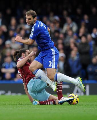 Andy Carroll of West Ham United tackles Branislav Ivanovic of Chelsea - Barclays Premier League - Chelsea vs West Ham United - Stamford Bridge Stadium - London - England - 26th December 2014 - Pic Robin Parker Sportimage EDITORIAL USE ONLY. No use with unauthorised audio, video, data, fixture lists, club league logos or live services. Online in-match use limited to 120 images, no video emulation. No use in betting, games or single club league player publications. DSC_7766
