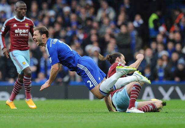 Andy Carroll of West Ham United tackles Branislav Ivanovic of Chelsea - Barclays Premier League - Chelsea vs West Ham United - Stamford Bridge Stadium - London - England - 26th December 2014 - Pic Robin Parker Sportimage EDITORIAL USE ONLY. No use with unauthorised audio, video, data, fixture lists, club league logos or live services. Online in-match use limited to 120 images, no video emulation. No use in betting, games or single club league player publications. DSC_7768